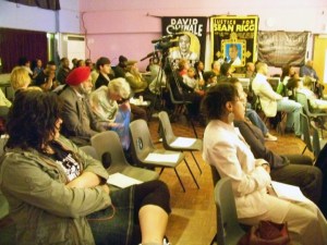 The audience listens